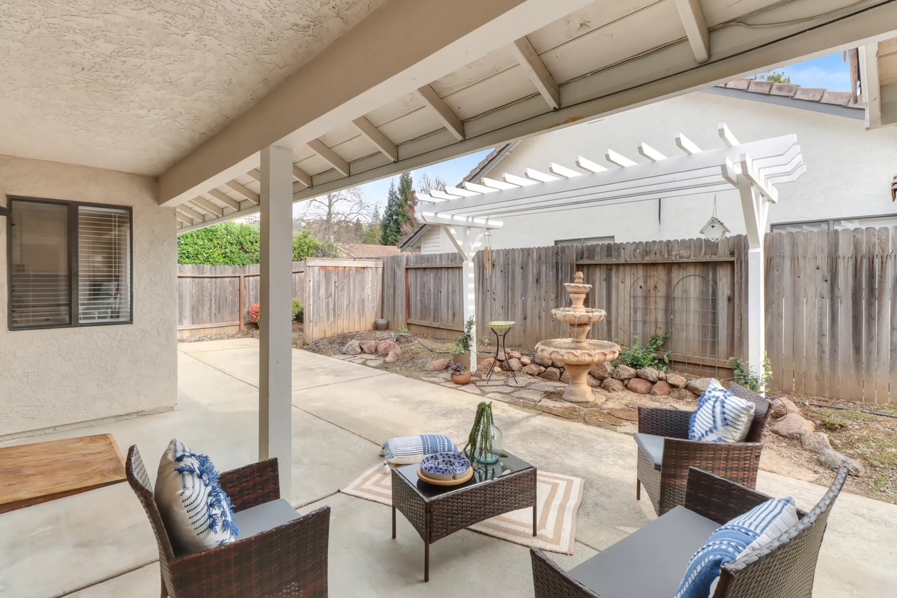 Peaceful backyard patio with fountain at Sophie's Homecare